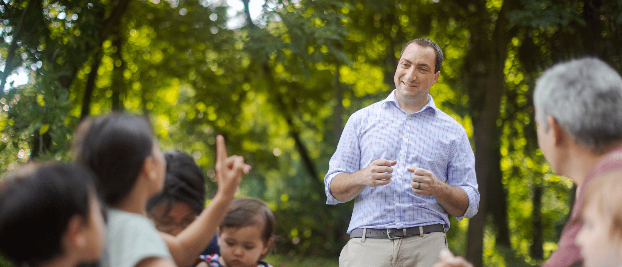 candidate scott goldberg speaking to constituents in a park